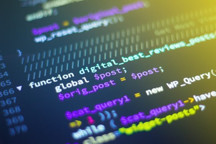 Developer comparing LLM fine-tuning frameworks on a laptop terminal