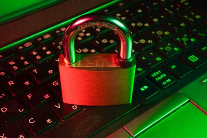 LLM PII redaction security concept: a red padlock resting on a computer keyboard